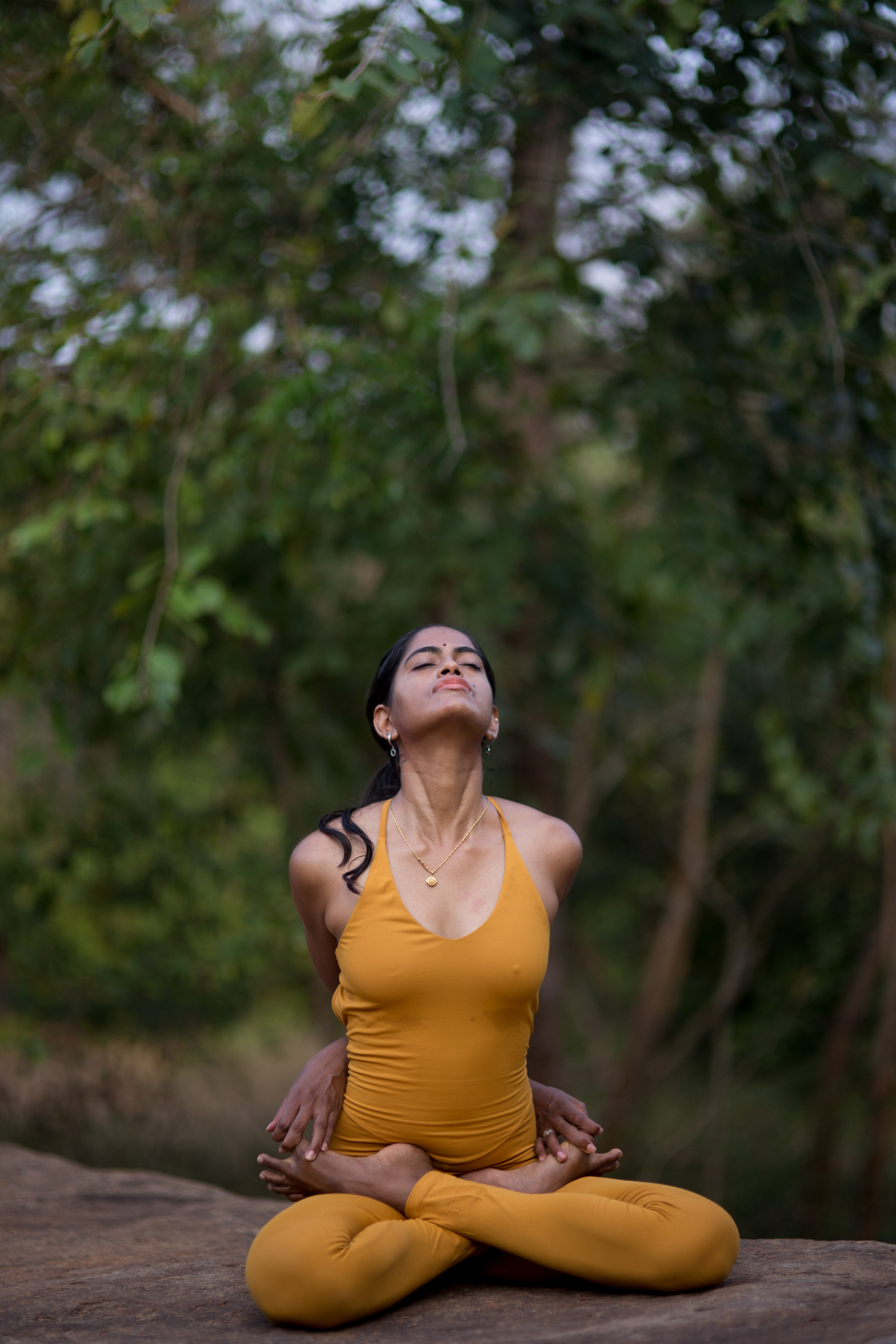 Sneha meditating in lotus pose